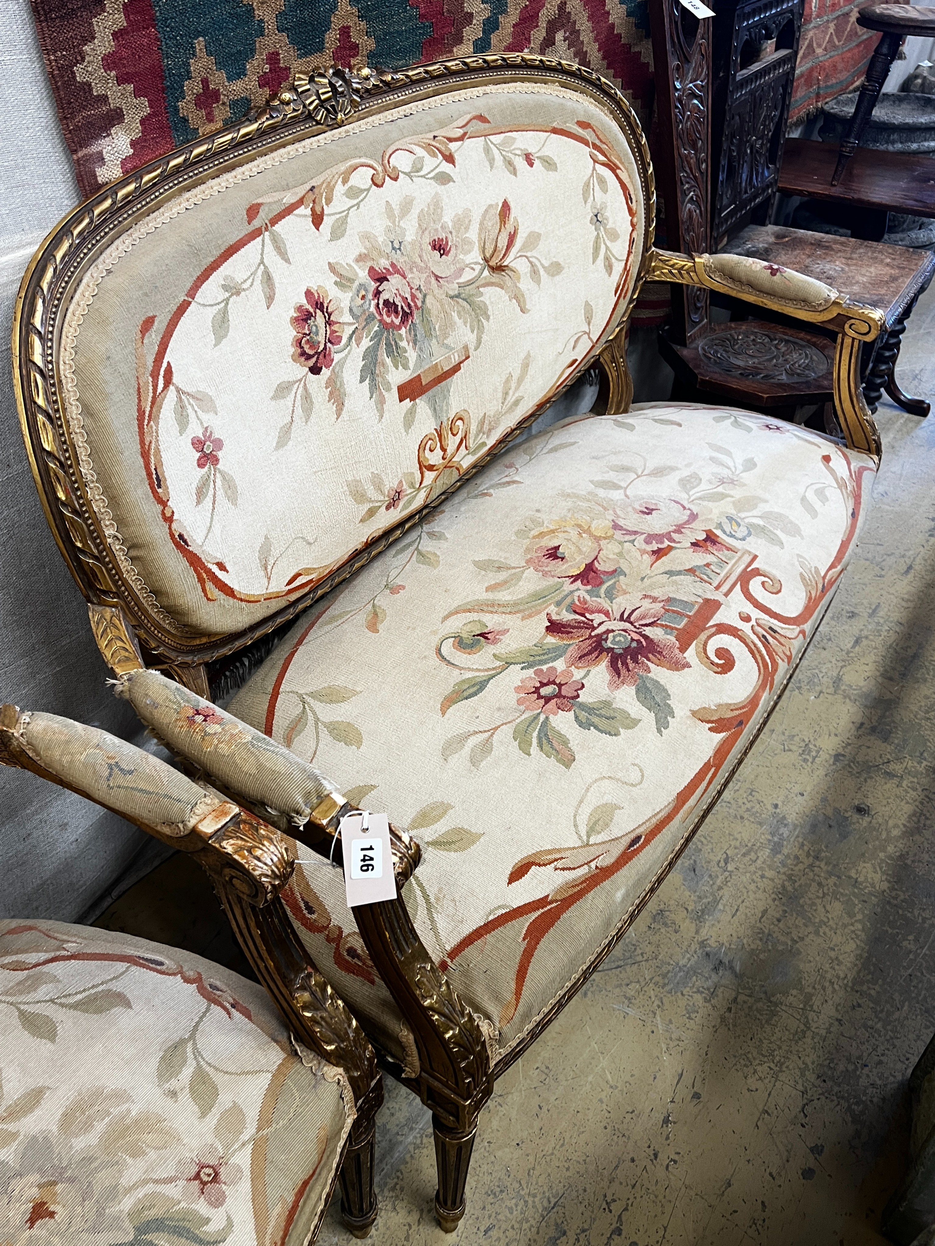 A Louis XVI style carved giltwood five piece salon suite, settee length 123cm, height 95cm